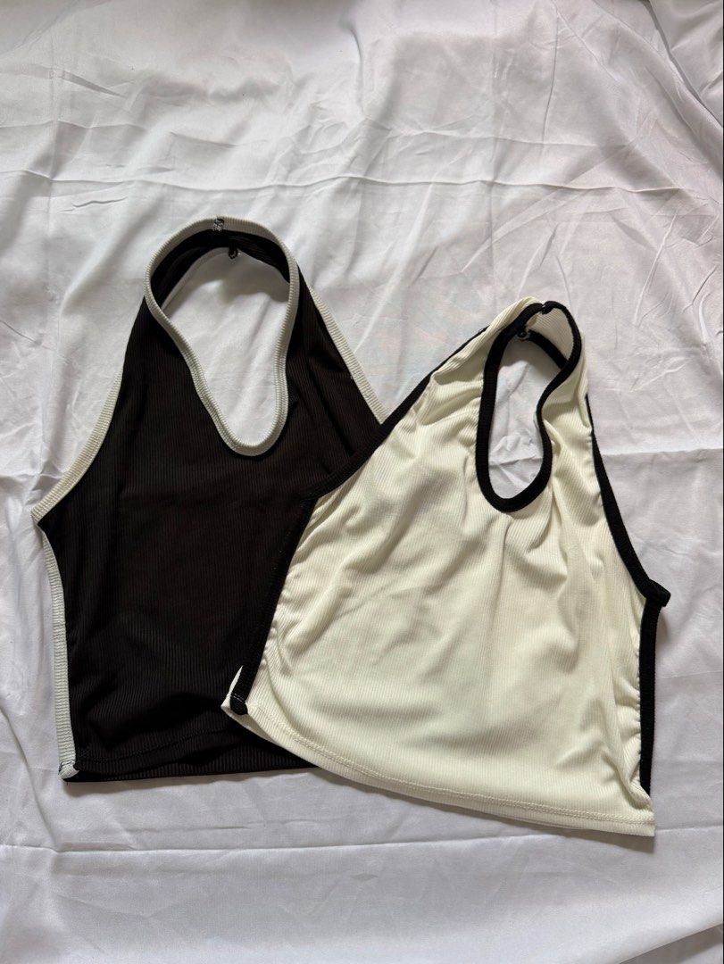 Buy 1 take 1 Ribbed Halter Crop Top Set Black and White (Category: Sleeveless) located in Las Pinas. Submitted by ann.co. (Listing ID 1467674139, Image 1). Description: - BUY 1 TAKE 1 Includes 2 pieces: Black with white trim & White with black trim - Style: Sleeveless, deep V-neck, and open back with a back strap - Material: Stretchy and comfortable ribbed fabric - Versatile: Easy to match with high-waisted jeans, shorts, or skirts - Perfect for: