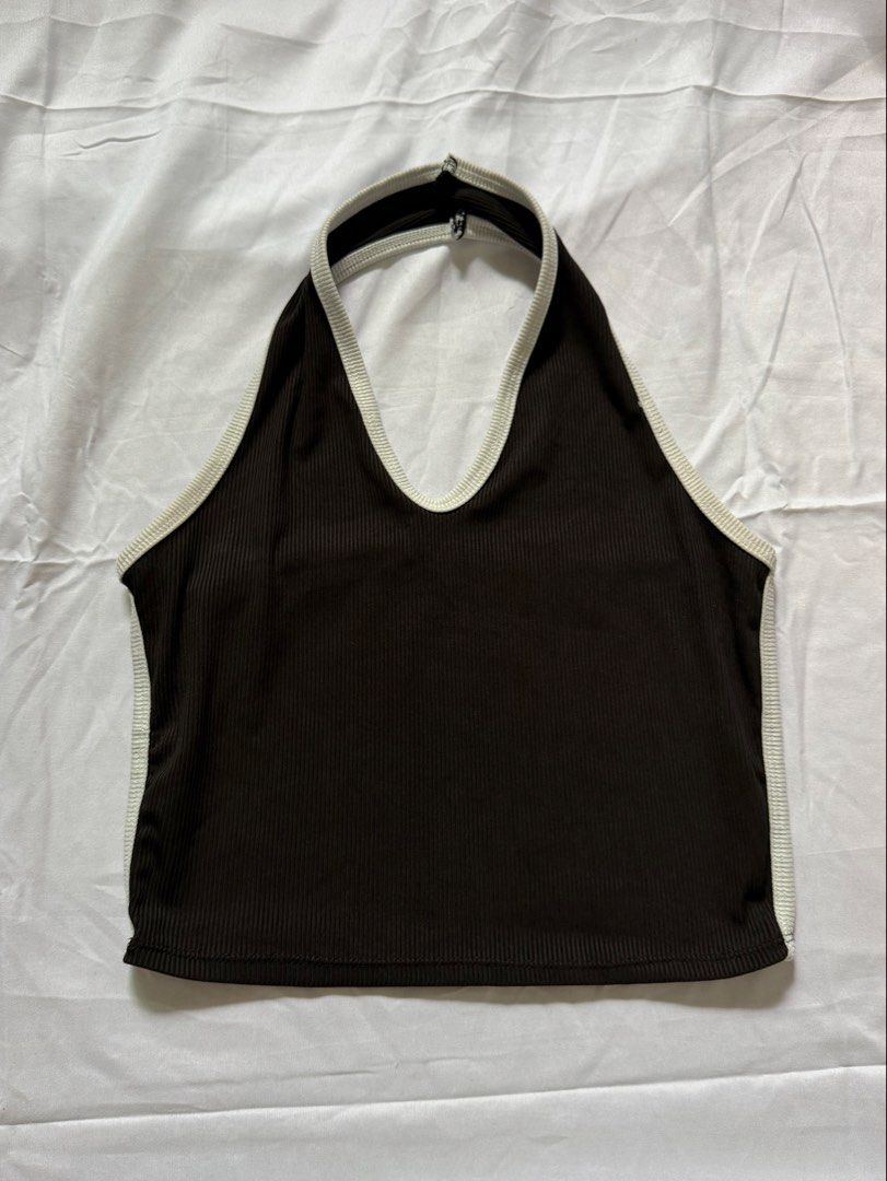 Buy 1 take 1 Ribbed Halter Crop Top Set Black and White (Category: Sleeveless) located in Las Pinas. Submitted by ann.co. (Listing ID 1467674139, Image 2). Description: - BUY 1 TAKE 1 Includes 2 pieces: Black with white trim & White with black trim - Style: Sleeveless, deep V-neck, and open back with a back strap - Material: Stretchy and comfortable ribbed fabric - Versatile: Easy to match with high-waisted jeans, shorts, or skirts - Perfect for: