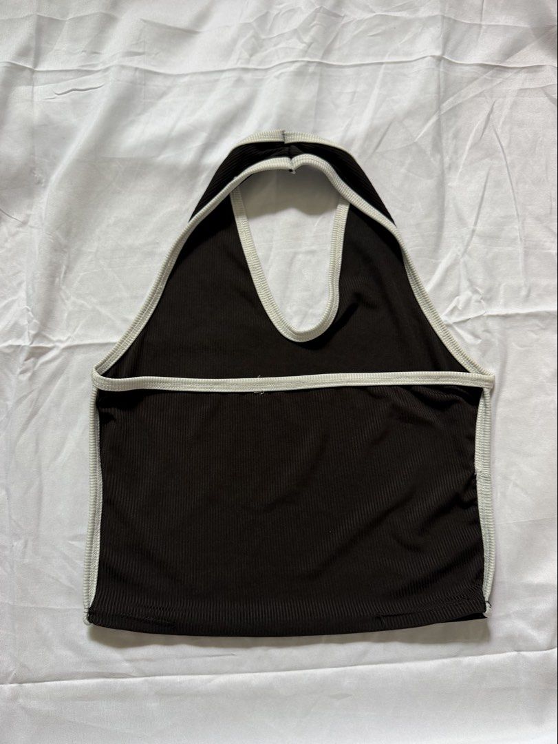 Buy 1 take 1 Ribbed Halter Crop Top Set Black and White (Category: Sleeveless) located in Las Pinas. Submitted by ann.co. (Listing ID 1467674139, Image 3). Description: - BUY 1 TAKE 1 Includes 2 pieces: Black with white trim & White with black trim - Style: Sleeveless, deep V-neck, and open back with a back strap - Material: Stretchy and comfortable ribbed fabric - Versatile: Easy to match with high-waisted jeans, shorts, or skirts - Perfect for: