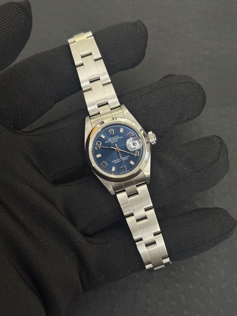 Rolex Oyster Perpetual Date Blue Dial Watch (Category: Luxury Watches) located in Manila. Submitted by michaelnicdao0702 (Listing ID 1467698949, Image 1). Description: -Rolex op date 26 blue arabic dial Ref: 79160 Year 1999 Watch box and authentication - Classic Rolex Oyster Perpetual Date wristwatch - Striking blue dial with Arabic numerals at 3, 6, and 9 o'clock - Durable stainless steel Oyster bracelet with brushed finish - Date window with cy