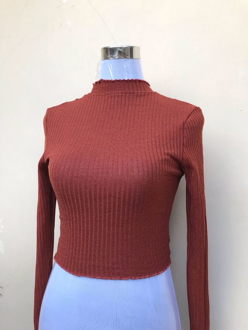 Rust orange ribbed long sleeve crop top (Category: Longsleeves) located in Quezon City. Submitted by ezrakeith (Listing ID 1467805897, Image 1). Description: - Color: Rust orange - Style: Ribbed long-sleeve crop top with high neckline - Details: Lettuce hem trim on collar and hem - Fit: Fitted silhouette, soft knit fabric - Use: Great layering piece for cooler weather.