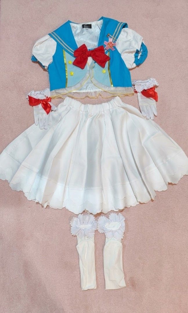 Sailor Moon inspired (Category: Sets or Coordinates) located in Manila. Submitted by carolgaza14 (Listing ID 1467715207, Image 1). Description: ✨Sailor Moon Inspired Magical Girl Dress Set✨ Adorable 2-piece magical cosplay set laid flat on a soft pink background. Top: - Light blue sailor vest with classic sailor collar + gold piping trim - White short puff sleeves with light blue ribbon detail on the arms - Big statement red satin bow in the cent