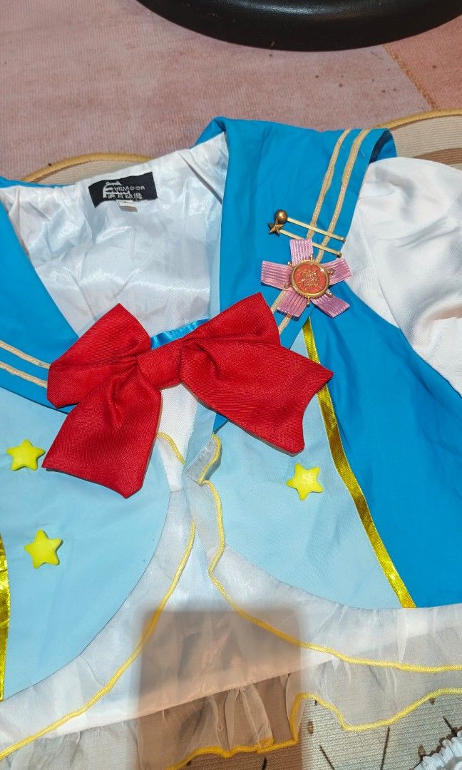 Sailor Moon inspired (Category: Sets or Coordinates) located in Manila. Submitted by carolgaza14 (Listing ID 1467715207, Image 2). Description: ✨Sailor Moon Inspired Magical Girl Dress Set✨ Adorable 2-piece magical cosplay set laid flat on a soft pink background. Top: - Light blue sailor vest with classic sailor collar + gold piping trim - White short puff sleeves with light blue ribbon detail on the arms - Big statement red satin bow in the cent