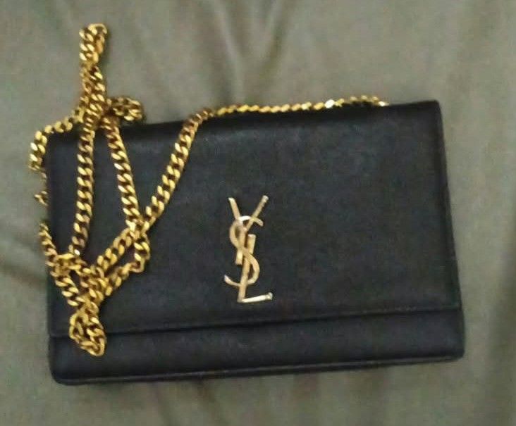 PA Pm po sa FB Libra de Ana... Saint Laurent YSL Black Leather Chain Bag (Category: Luxury Bags & Wallets) located in Cabanatuan. Submitted by almaespino24263 (Listing ID 1467644259, Image 2). Description: - Brand: Saint Laurent - Style: Crossbody / Shoulder Bag - Material: Black textured leather - Hardware: Gold-tone - Closure: Magnetic snap with gold foil YSL stamp - Strap: Chunky gold chain - Interior: Fabric lining with leather brand tag - Co