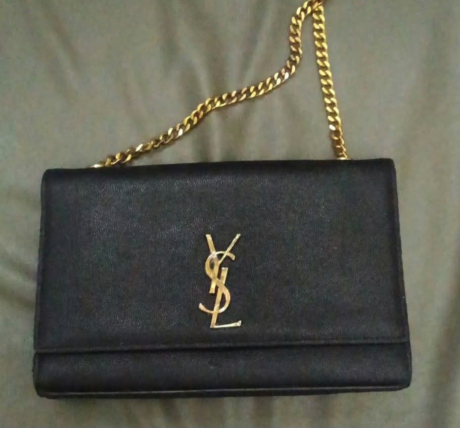 PA Pm po sa FB Libra de Ana... Saint Laurent YSL Black Leather Chain Bag (Category: Luxury Bags & Wallets) located in Cabanatuan. Submitted by almaespino24263 (Listing ID 1467644259, Image 1). Description: - Brand: Saint Laurent - Style: Crossbody / Shoulder Bag - Material: Black textured leather - Hardware: Gold-tone - Closure: Magnetic snap with gold foil YSL stamp - Strap: Chunky gold chain - Interior: Fabric lining with leather brand tag - Co