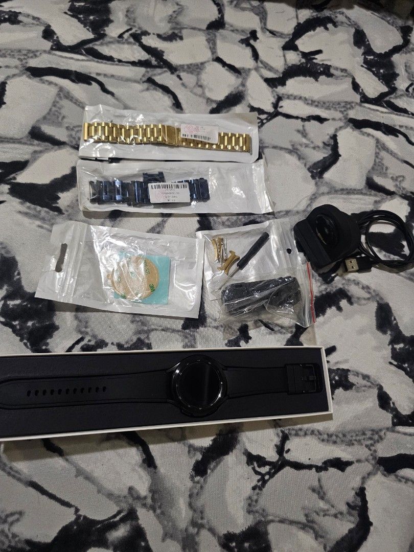 Samsung galaxy watch 4 classi (Category: Wearables & Smart Watches) located in Manila. Submitted by gsauce890 (Listing ID 1467788094, Image 2). Description: - Brand/Model: Samsung Galaxy Watch4 Classic - Condition: Good (Layered 4) - Includes original box, magnetic charger, and extra straps (gold and blue metal links) - Additional accessories and tools included as shown in photos - Meetup location: Sta. Lucia East Grand Mall, Felix Ave (Marcos Hw