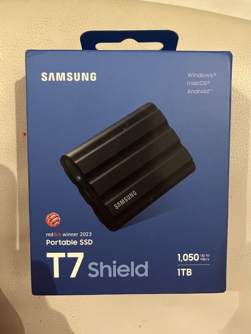 Samsung T7 Shield 1TB Portable SSD (Category: Hard Disks & Thumbdrives) located in Indang. Submitted by loveleen09 (Listing ID 1467633612, Image 1). Description: - Brand: Samsung T7 Shield 1TB Portable SSD - Color: Black - Condition: Brand new, sealed in original blue retail packaging - Speed: Lightning-fast file transfers up to 1,050 MB/s - Durability: Rugged design with IP65 water and dust resistance (2023 Red Dot Award Winner) - Compatibility: