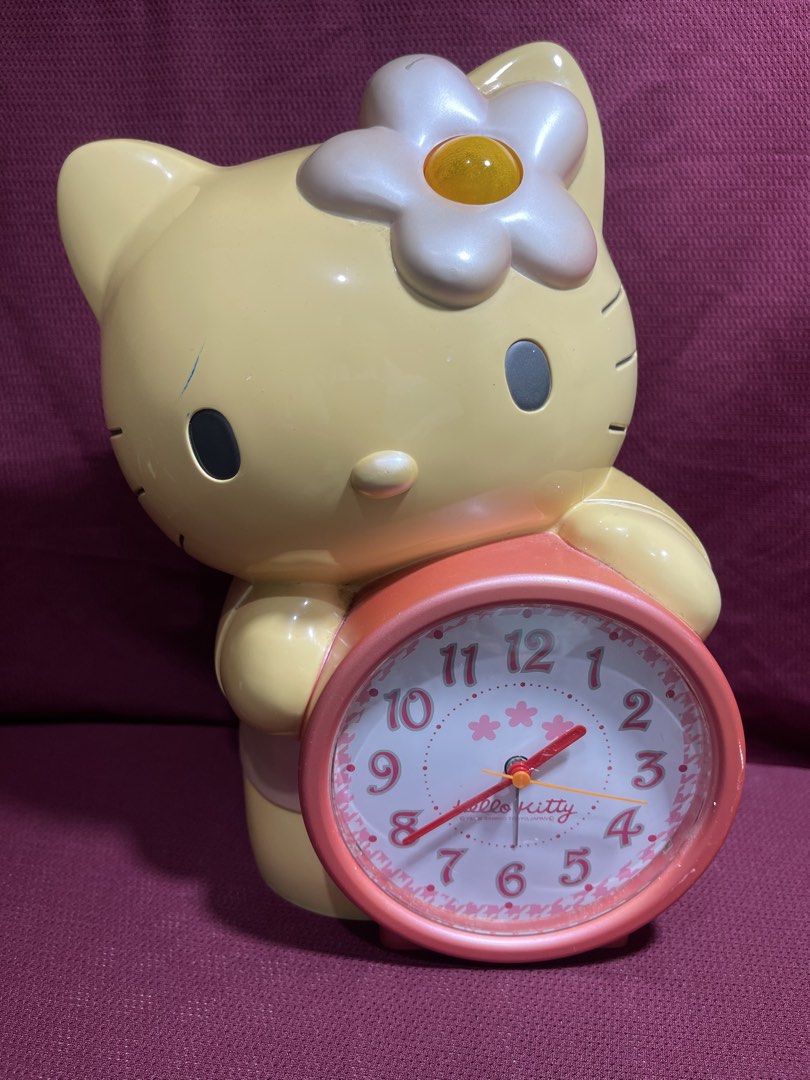 Sanrio Hello Kitty Vintage Alarm Clock (Category: Clocks) located in Manila. Submitted by dstrangerthings (Listing ID 1467772418, Image 1). Description: - Authentic 1999 Sanrio vintage collectible - Functional analog alarm clock holding a pink clock - Condition: Shows visible scuffs, paint chipping, and discoloration due to age ✅display nlng/collection clock not working anymore.