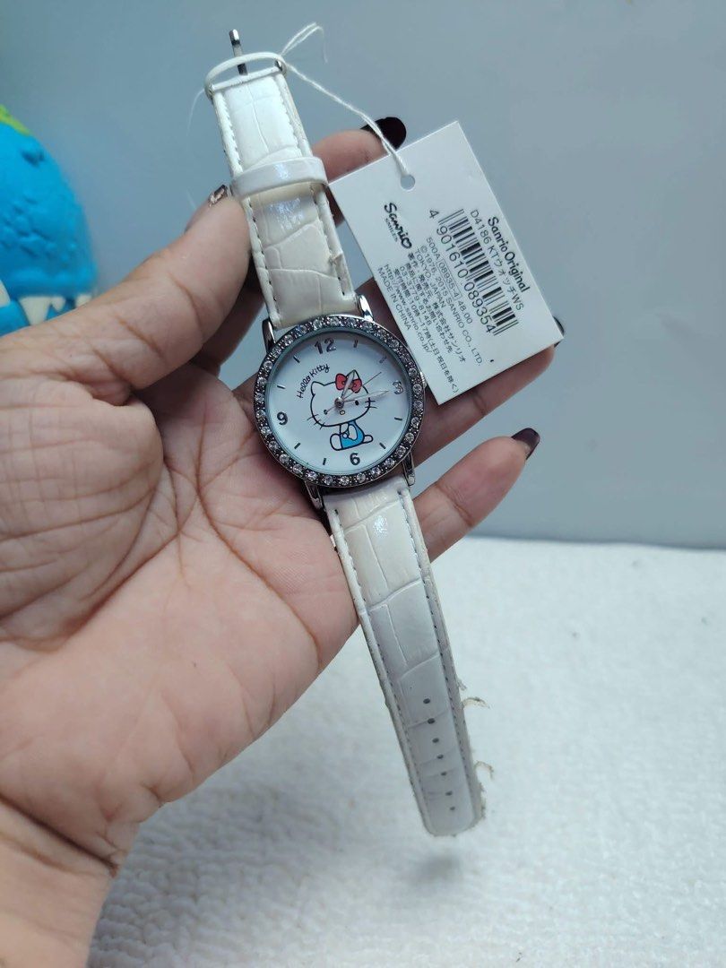 Sanrio Original Hello Kitty Watch White Strap (Category: Women's Watches) located in Manila. Submitted by janetecson05 (Listing ID 1467626066, Image 1). Description: - 100% Authentic Sanrio Original Kitty wristwatch - Elegant white crocodile-embossed leather strap - Sparkling silver round dial with a rhinestone-studded bezel - Cute Kitty graphic on the face with clear numerical markers at 12, 3, 6, and 9 - Brand new with original store tag attach