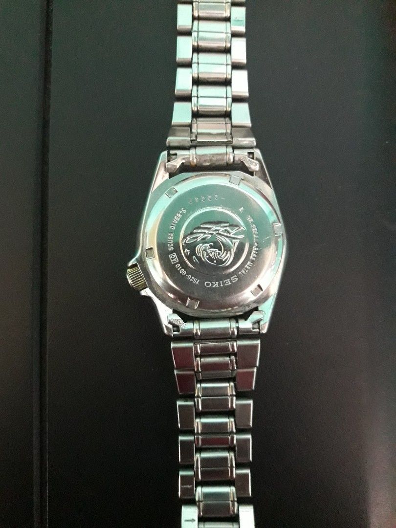 Seiko Automatic Scuba Diver's 200m Watch 7S26-0010 (Category: Men's Watches) located in Paranaque City. Submitted by omaraguirre (Listing ID 1467673327, Image 2). Description: - Brand/Model: Seiko Automatic Dive Watch - Dial & Bezel: White dial with gold accents on the bezel and crown - Features: Day-date window at 3 o'clock, rotating bezel - Hardware: Silver-tone metal bracelet with Seiko-branded deployment clasp, stainless steel case back with 