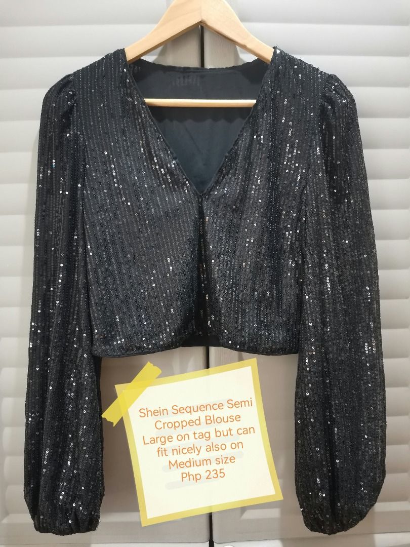 Shein Black Sequin Semi Cropped Blouse Size L (Category: Blouses) located in Manila. Submitted by mahanaim.67c328 (Listing ID 1467761144, Image 1). Description: Shein black sequin semi cropped blouse, long balloon sleeves with elastic cuffs. Deep V-neckline. Covered in black sequins all over. Size large on tag, fits medium to large comfortably. 100 percent polyester material. Great statement piece for night outs or parties..