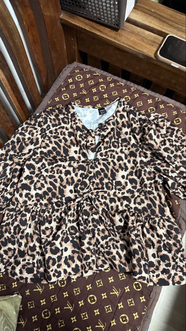 SHEIN Leopard Print Tie Front Peplum Blouse (Category: Blouses) located in Manila. Submitted by backupaccount2 (Listing ID 1467785361, Image 1). Description: - Brand: SHEIN - Pattern: All-over leopard print - Features: Puff sleeves, tie front detail, ruffled peplum hem - Fabric: Lightweight and comfortable - Styling: Perfect for casual days out or dressing up with jeans.