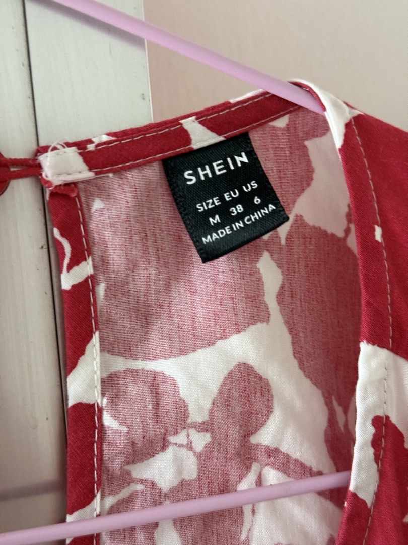 SHEIN Red White Floral Open Back Dress Size M (Category: Dresses) located in Mandaluyong City. Submitted by declutteringmylife101 (Listing ID 1467630921, Image 3). Description: - Brand: SHEIN - Size: Medium (EU 38, US 6) - Design: Red and white floral print, open back with delicate cross-straps, and trendy puff sleeves - Fit: Comfortable elasticated waistline - Material: Light, breezy fabric ideal for warm weather - Condition: Excellent, no flaws
