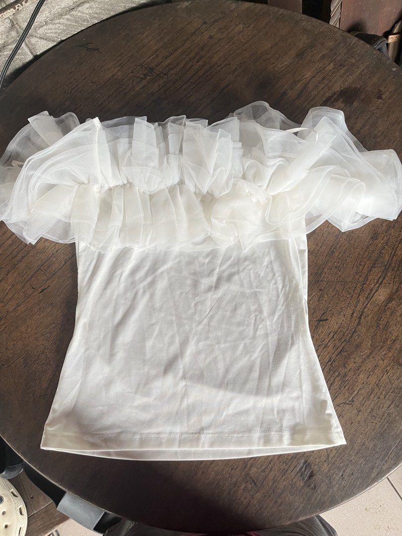 Shein White Ruffle Tulle Off Shoulder Top (Category: Sleeveless) located in Alitagtag. Submitted by jaaaimr (Listing ID 1467677028, Image 2). Description: - Brand: Shein - Size: S (EU 36, US 4) - Color: White - Design: Off-shoulder with layered sheer mesh ruffle details on chest and sleeves - Condition: Used once with no damage.