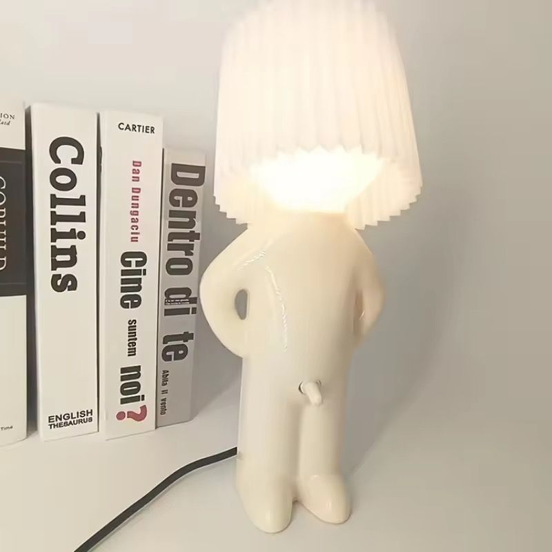 Shy Boy Table Lamp Novelty Night Light (Category: Lighting) located in Subic. Submitted by anything_lovely_under_the_sun (Listing ID 1467758833, Image 1). Description: - Quirky novelty table lamp shaped like a little figure - White ceramic body featuring a stylish pleated lampshade head - Hilarious and convenient switch design right on the front - Emits a cozy warm glow, making it a great conversation piece - Ideal for your desk or bedside table 