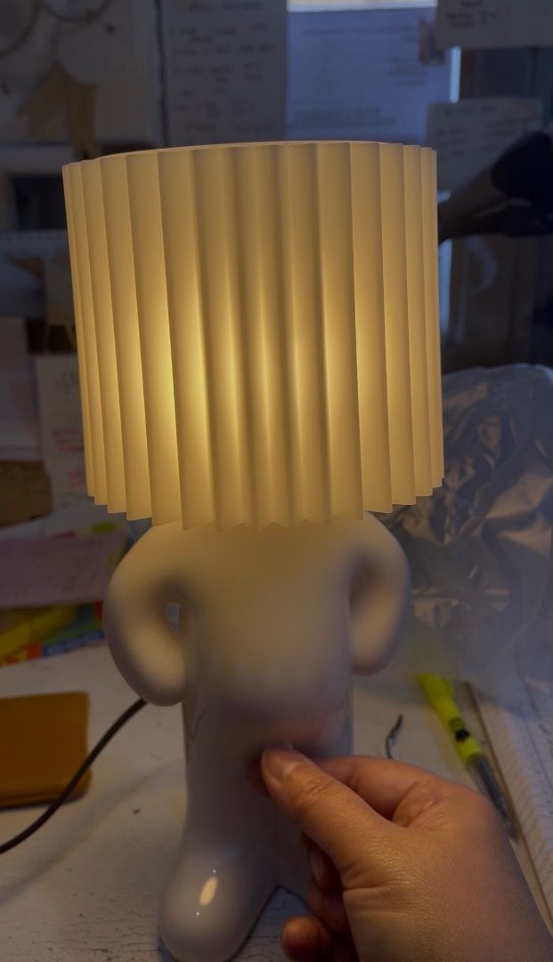 Shy Boy Table Lamp Novelty Night Light (Category: Lighting) located in Subic. Submitted by anything_lovely_under_the_sun (Listing ID 1467758833, Image 3). Description: - Quirky novelty table lamp shaped like a little figure - White ceramic body featuring a stylish pleated lampshade head - Hilarious and convenient switch design right on the front - Emits a cozy warm glow, making it a great conversation piece - Ideal for your desk or bedside table 