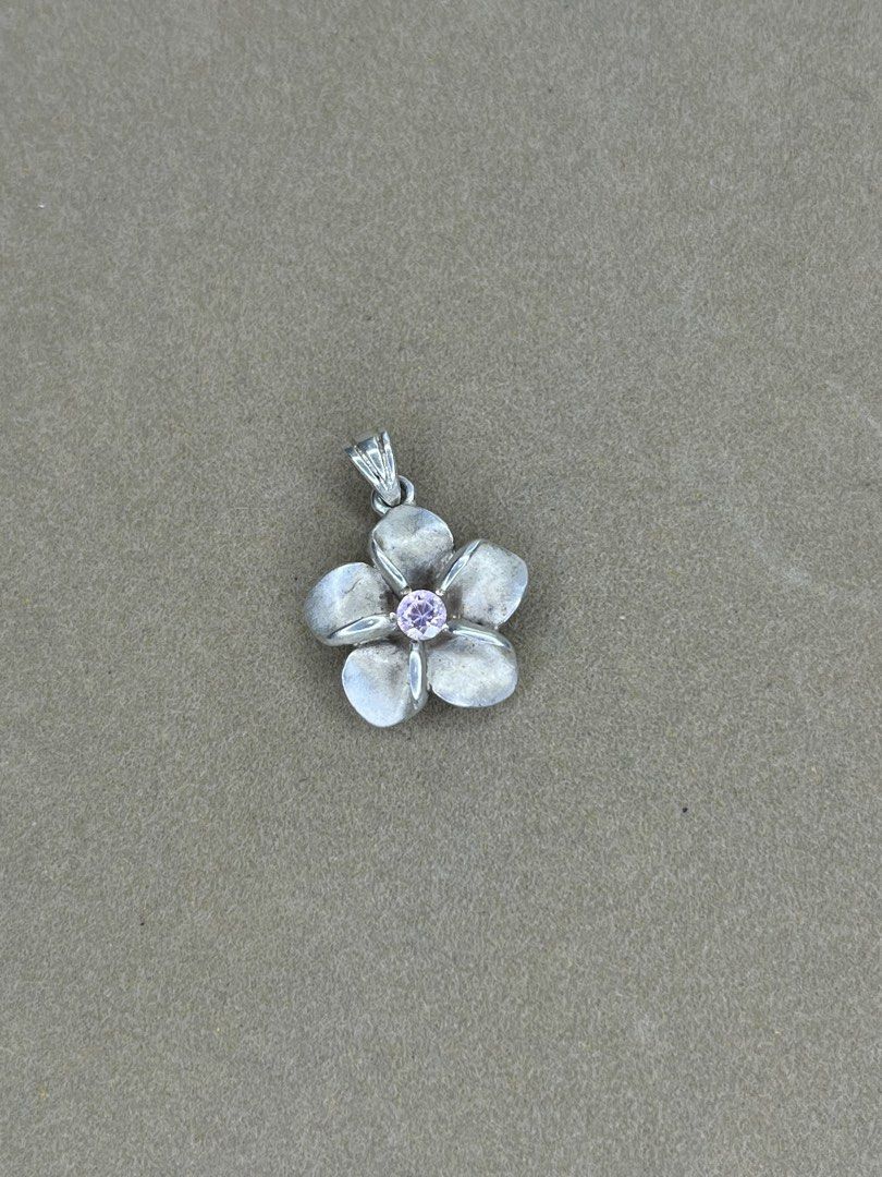 Silver Flower Pendant with Pink Gemstone (Category: Necklaces) located in Bulacan. Submitted by vintagetreasureby.mivida (Listing ID 1467642428, Image 1). Description: - Design: 5-petal silver flower with a striking round pink gemstone center - Details: Beautiful textured detailing on the reverse side of each petal - Versatility: Small loop at the top, fits most standard necklaces and cords - Size: Compact and lightweight for comfortable daily we