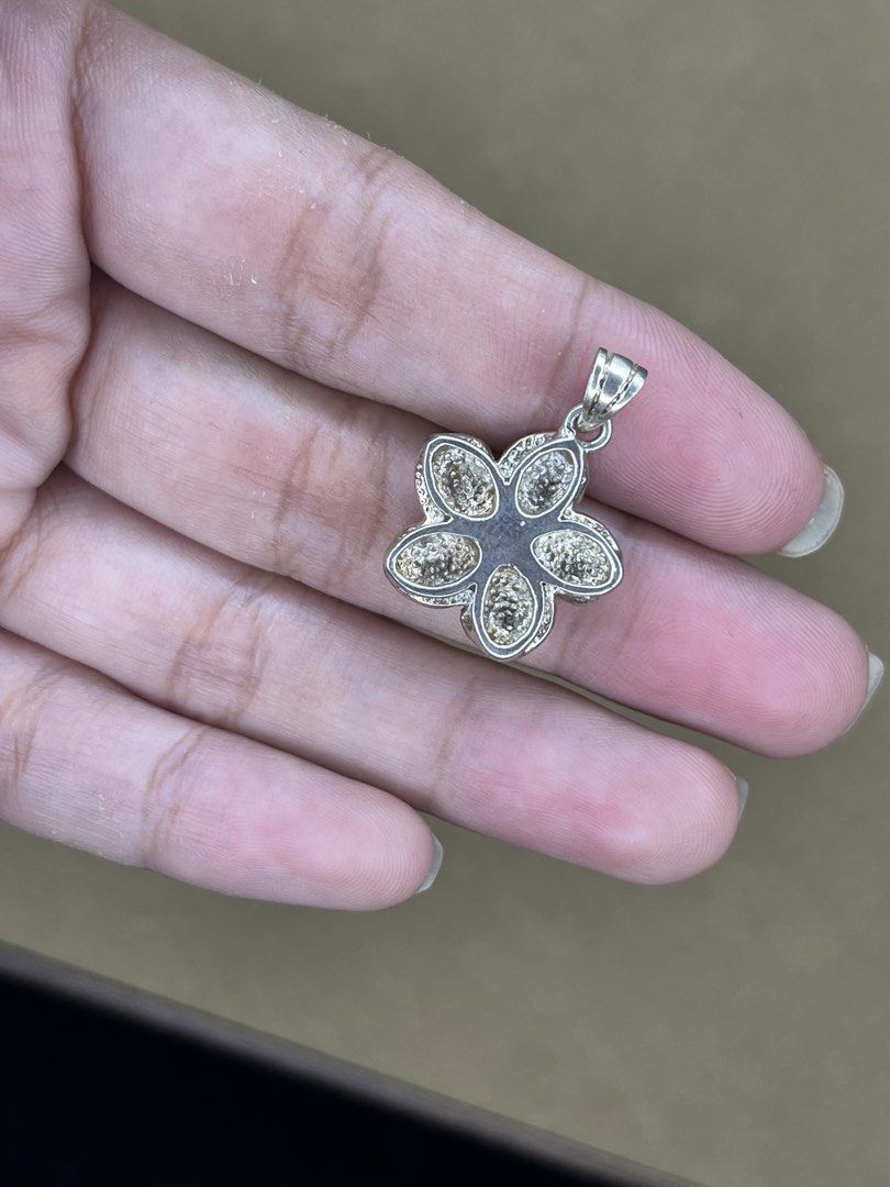Silver Flower Pendant with Pink Gemstone (Category: Necklaces) located in Bulacan. Submitted by vintagetreasureby.mivida (Listing ID 1467642428, Image 3). Description: - Design: 5-petal silver flower with a striking round pink gemstone center - Details: Beautiful textured detailing on the reverse side of each petal - Versatility: Small loop at the top, fits most standard necklaces and cords - Size: Compact and lightweight for comfortable daily we
