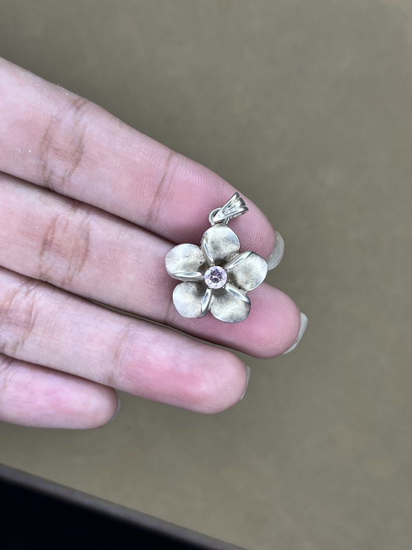 Silver Flower Pendant with Pink Gemstone (Category: Necklaces) located in Bulacan. Submitted by vintagetreasureby.mivida (Listing ID 1467642428, Image 2). Description: - Design: 5-petal silver flower with a striking round pink gemstone center - Details: Beautiful textured detailing on the reverse side of each petal - Versatility: Small loop at the top, fits most standard necklaces and cords - Size: Compact and lightweight for comfortable daily we