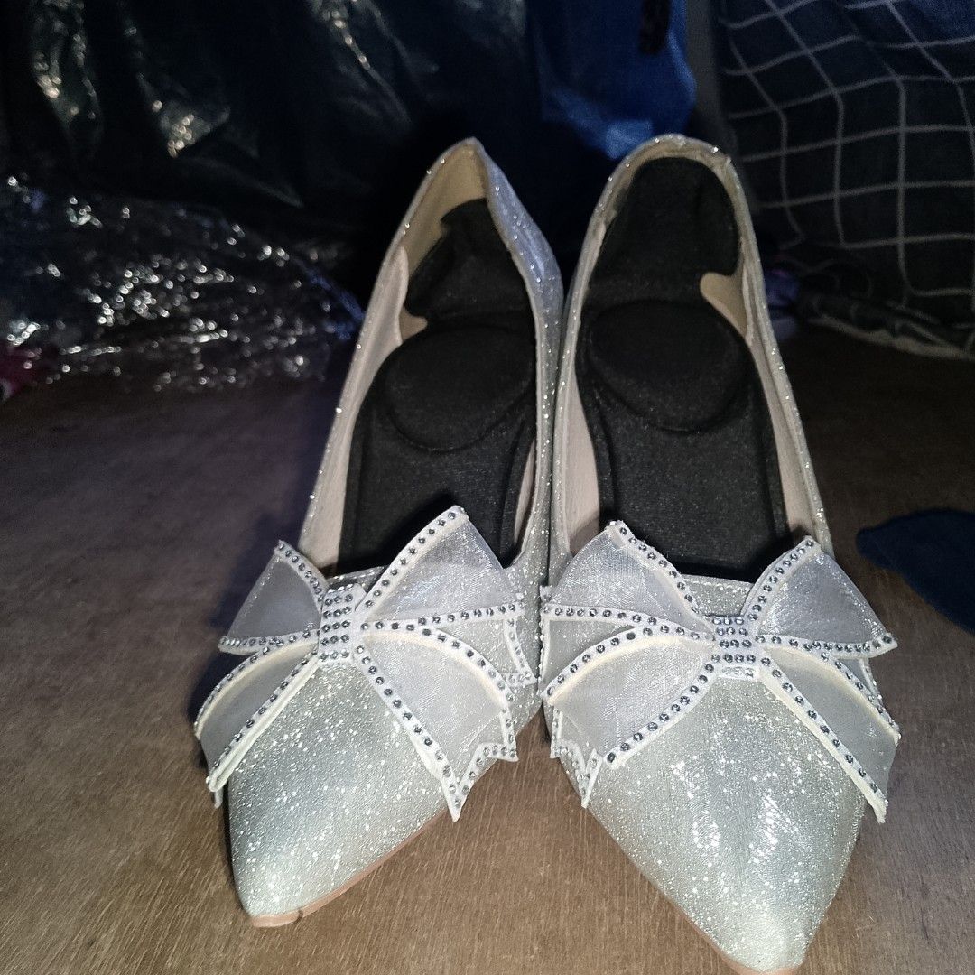 Silver Glitter Stiletto Heels With Bow (Category: Heels) located in Manila. Submitted by labeaalay48867 (Listing ID 1467726395, Image 1). Description: - Color & Style: Sparkly silver high heels with a chic pointed toe - Details: Features a beautiful sparkly sheer bow on the front and a classic stiletto heel - Comfort: Comes with black cushion inserts already inside the soles for extra comfort - Condition: Worn only once nung graduation - Perfect 