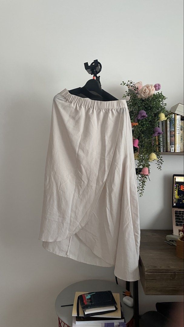 Sleryar Beige Wrap Midi Skirt (Category: Skirts) located in Baguio. Submitted by baeeuxx (Listing ID 1467681820, Image 1). Description: - Brand: Sleryar - Color: Versatile neutral beige - Style: Wrap midi skirt with trendy asymmetrical hem and draping - Comfort: Elastic waistband for an easy pull-on fit - Fabric: Lightweight and breathable, ideal for warmer days - Matching: Easily pairs with your favorite tops for any casual or chic look.