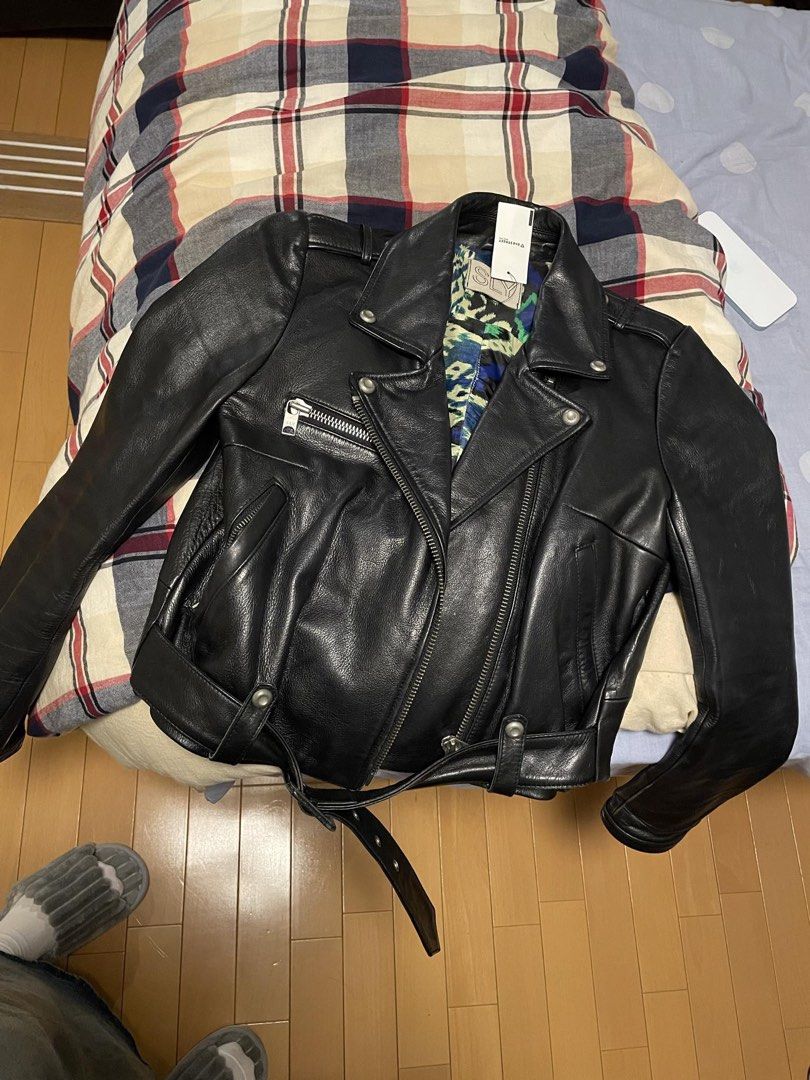 SLY Black Leather Biker Jacket with Belt and Patterned Lining (Category: Coats, Jackets and Outerwear) located in Manila. Submitted by yearielle19700 (Listing ID 1467705106, Image 1). Description: - Brand: SLY - Color: Classic black with silver-tone hardware - Material: Premium leather - Design: Asymmetric front zip, zipped chest pocket, snap lapels, and buckled waist belt - Condition: lightly used lang! No flaws .
