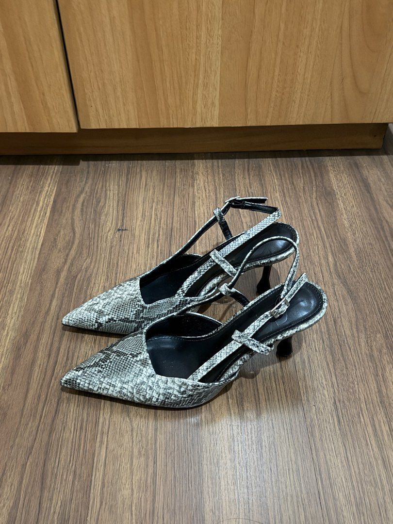 Snake Print Slingback Heels Size 38 (Category: Heels) located in Quezon City. Submitted by hellopucca (Listing ID 1467706683, Image 1). Description: - Style: Snakeskin print slingback heels - Color: Black and grey - Size: 38 - Features: Pointed toe, slim flared heel, adjustable ankle strap with buckle - Condition: Gently worn with minor scuffs on the bottom soles.