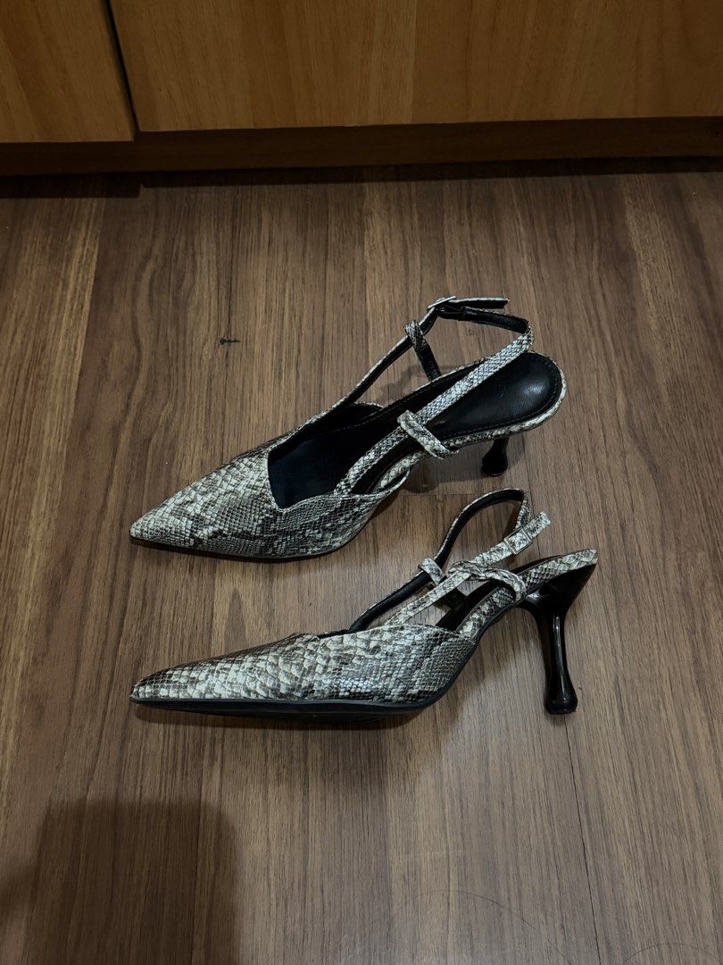 Snake Print Slingback Heels Size 38 (Category: Heels) located in Quezon City. Submitted by hellopucca (Listing ID 1467706683, Image 2). Description: - Style: Snakeskin print slingback heels - Color: Black and grey - Size: 38 - Features: Pointed toe, slim flared heel, adjustable ankle strap with buckle - Condition: Gently worn with minor scuffs on the bottom soles.
