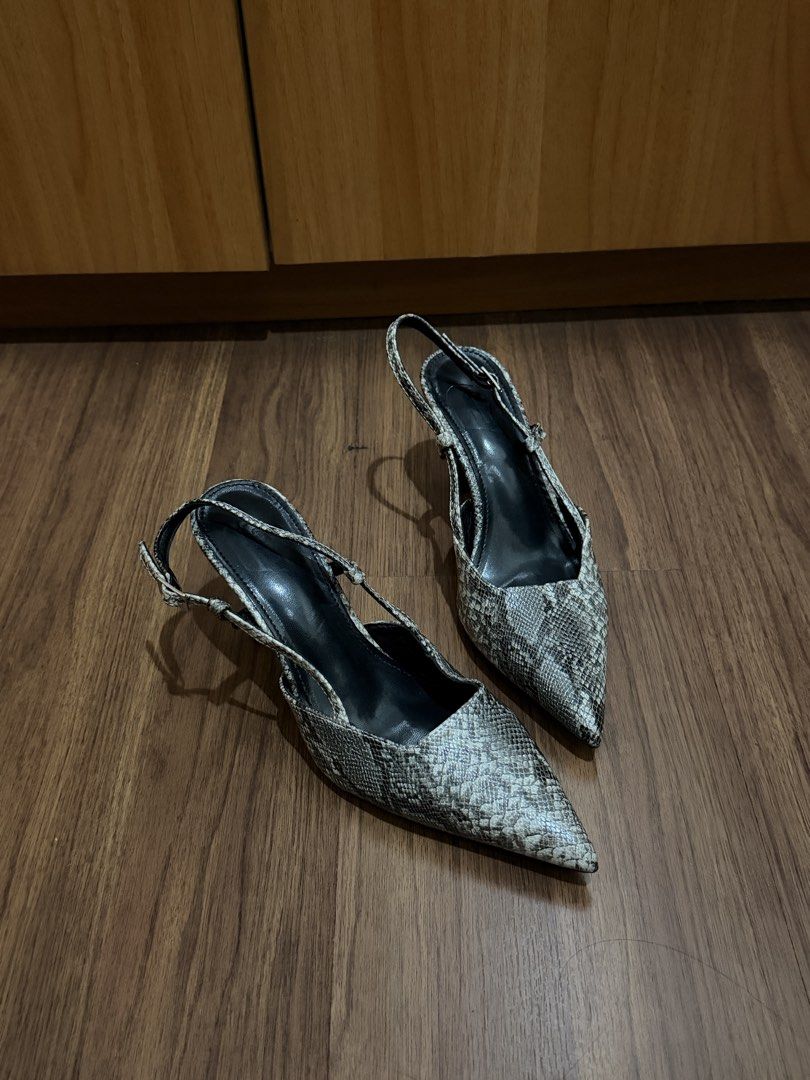 Snake Print Slingback Heels Size 38 (Category: Heels) located in Quezon City. Submitted by hellopucca (Listing ID 1467706683, Image 3). Description: - Style: Snakeskin print slingback heels - Color: Black and grey - Size: 38 - Features: Pointed toe, slim flared heel, adjustable ankle strap with buckle - Condition: Gently worn with minor scuffs on the bottom soles.