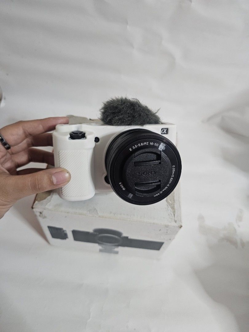 Sony ZV-E10 4K Mirrorless Camera with 16-50mm Lens (Category: Cameras) located in Marikina City. Submitted by aitaaaag (Listing ID 1467622477, Image 1). Description: - Sony ZV-E10 mirrorless camera body with white protective silicone case - E PZ 16-50mm f/3.5-5.6 OSS power zoom lens - Original box included - 1 Original battery - Pisen battery charger rfs: seldom used, additional funds for bills meetup and pickup only.