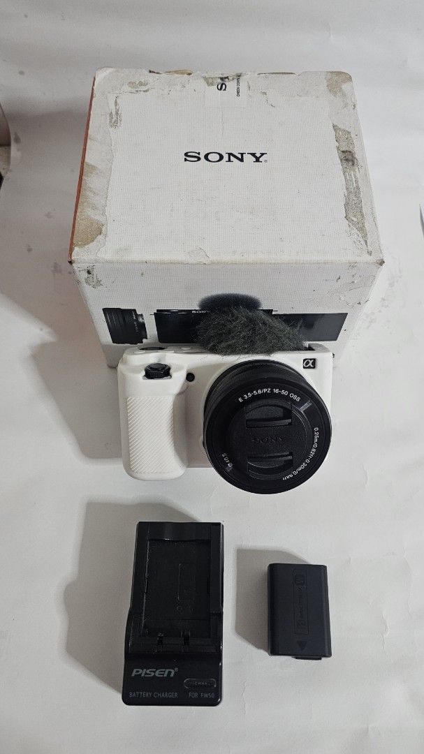 Sony ZV-E10 4K Mirrorless Camera with 16-50mm Lens (Category: Cameras) located in Marikina City. Submitted by aitaaaag (Listing ID 1467622477, Image 2). Description: - Sony ZV-E10 mirrorless camera body with white protective silicone case - E PZ 16-50mm f/3.5-5.6 OSS power zoom lens - Original box included - 1 Original battery - Pisen battery charger rfs: seldom used, additional funds for bills meetup and pickup only.