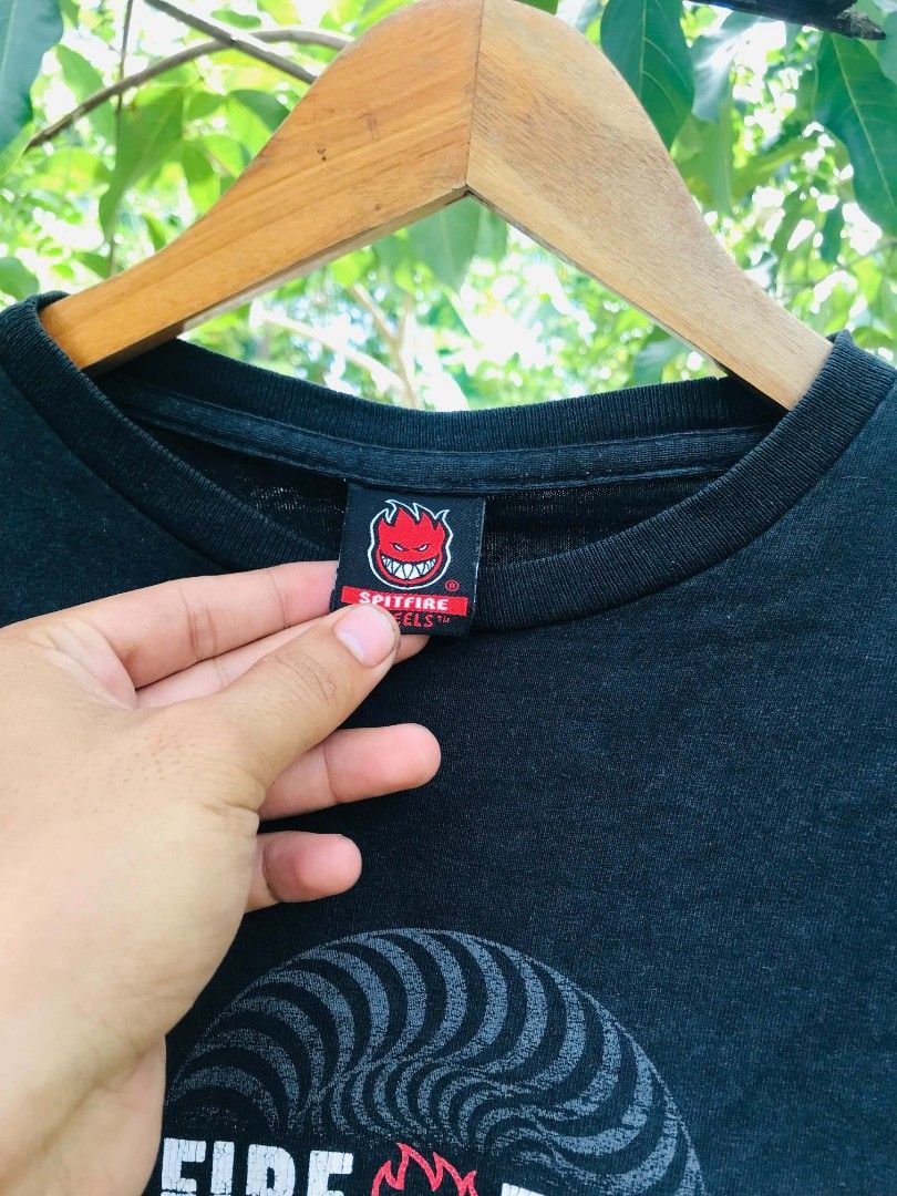 Spitfire Wheels Double Layer Long Sleeve T-Shirt Black Red (Category: Tshirts & Polo Shirts ) located in Camiling. Submitted by dinurobongtubol (Listing ID 1467651775, Image 3). Description: - Brand: Spitfire Wheels - Design: Black short sleeve tee with red layered long sleeves - Graphics: Big white and red swirl logo on chest, smaller logo on upper back - Details: Spitfire inner collar branding tag - Material: Comfortable, high-quality cotton - 