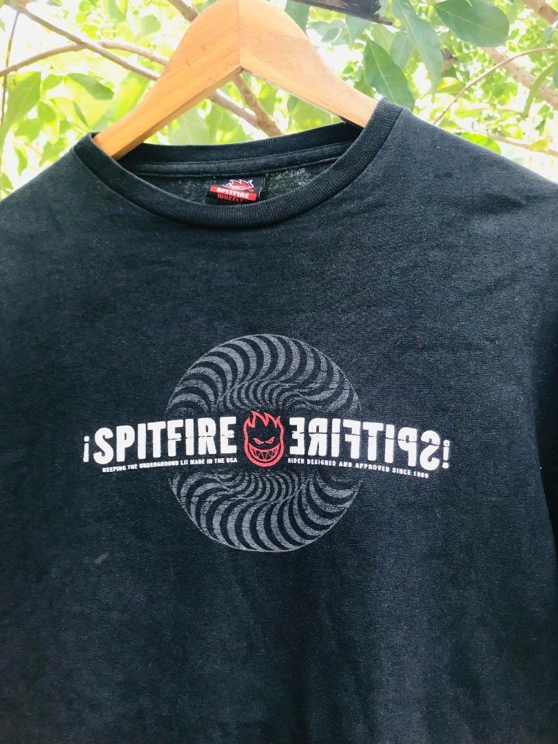 Spitfire Wheels Double Layer Long Sleeve T-Shirt Black Red (Category: Tshirts & Polo Shirts ) located in Camiling. Submitted by dinurobongtubol (Listing ID 1467651775, Image 2). Description: - Brand: Spitfire Wheels - Design: Black short sleeve tee with red layered long sleeves - Graphics: Big white and red swirl logo on chest, smaller logo on upper back - Details: Spitfire inner collar branding tag - Material: Comfortable, high-quality cotton - 