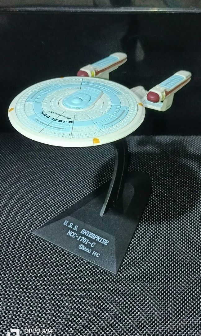 Star trek (Category: Vehicle & Diecast Models) located in Quezon City. Submitted by Bernz (Listing ID 1467708921, Image 2). Description: The image displays a collection of miniature starship figures from the Star Trek franchise, specifically representing various iterations of the iconic U.S.S. Enterprise fleet. These models are from the collectible Furuta Star Trek Starship Collection, recognizable by their specific oval black display stands, dis