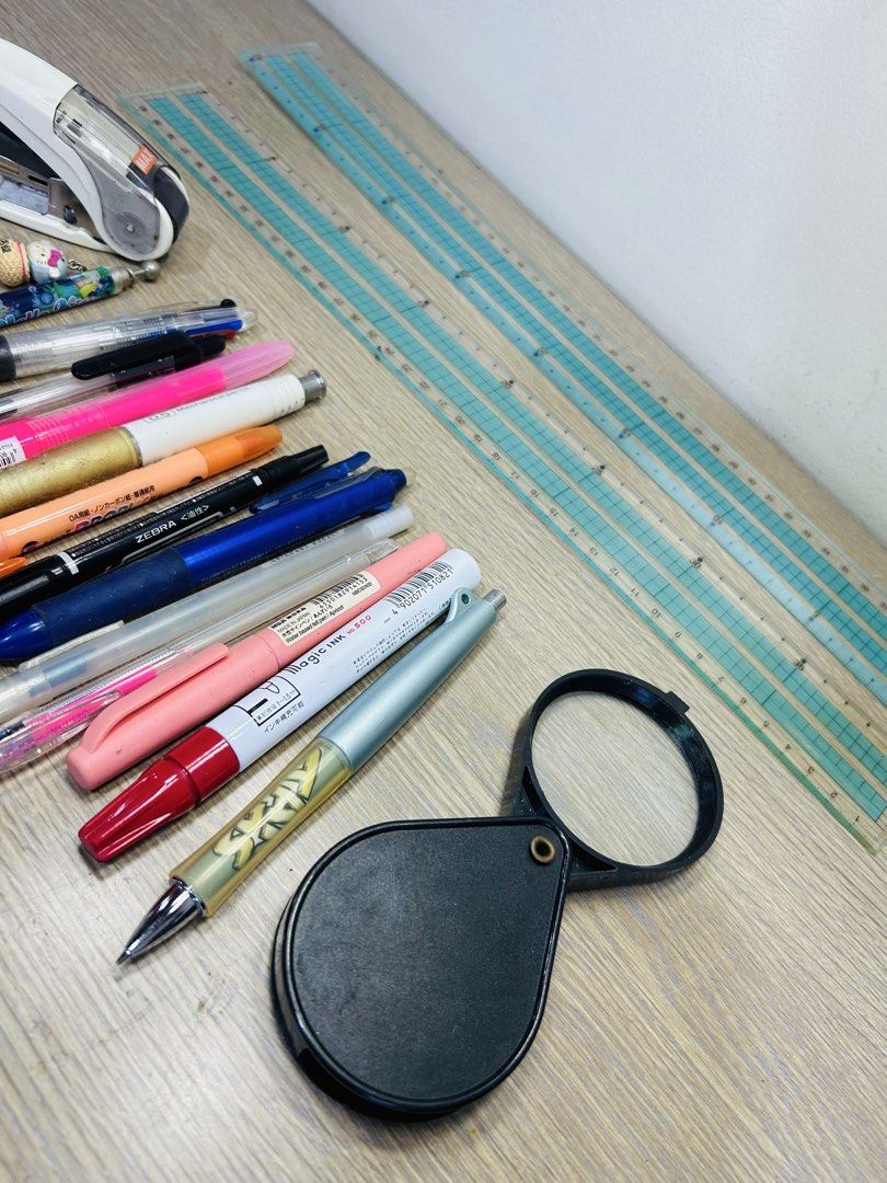 Stationery bundle with pens, stapler, ruler and magnifying glass (Category: Stationery & School Supplies) located in Manila. Submitted by starbalesukandjapansurplus (Listing ID 1467666548, Image 3). Description: Clearing out some desk items. Bundle includes a white stapler, various pens including Zebra and Pilot, clear rulers, and a black folding magnifying glass. All items show some signs of previous handling and normal wear. Selling everything 