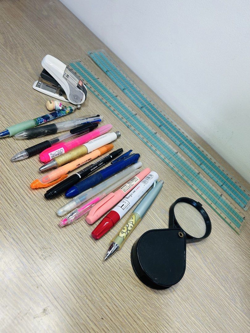 Stationery bundle with pens, stapler, ruler and magnifying glass (Category: Stationery & School Supplies) located in Manila. Submitted by starbalesukandjapansurplus (Listing ID 1467666548, Image 1). Description: Clearing out some desk items. Bundle includes a white stapler, various pens including Zebra and Pilot, clear rulers, and a black folding magnifying glass. All items show some signs of previous handling and normal wear. Selling everything 