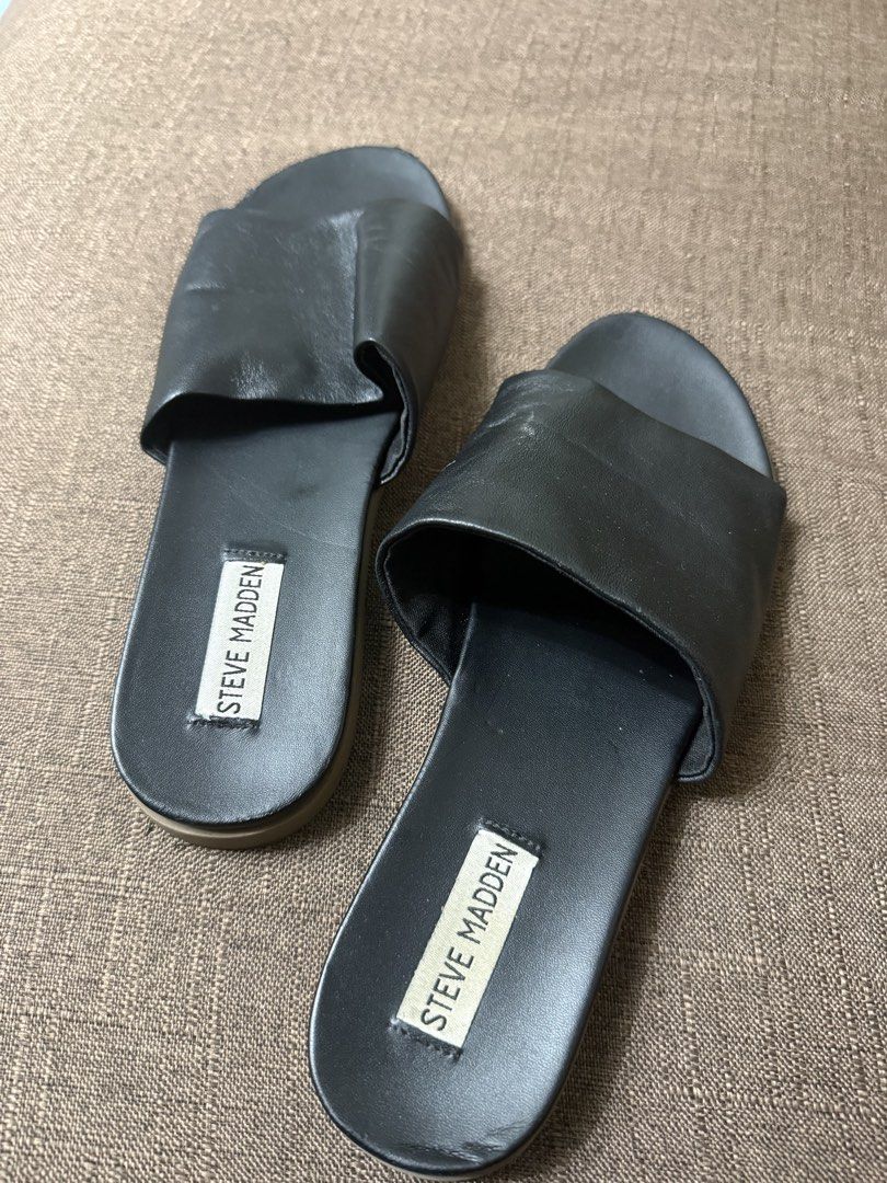 Steve Madden Black Slide Sandals (Category: Flats & Sandals) located in Cainta. Submitted by amswardrobe (Listing ID 1467837857, Image 3). Description: - Brand: Steve Madden - Color: Classic Black - Style: Slip-on slide sandals with wide foot strap and branded insole - Condition: Pre-loved with light wear around the toe edges - Features: Comfortable flat sole, ideal for daily casual wear.