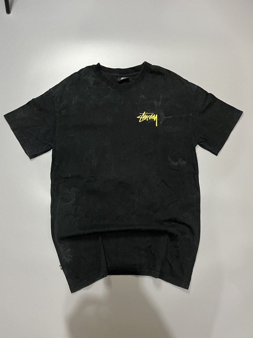 Stussy Graphic Tee Black Size S (Category: Tshirts & Polo Shirts ) located in Manila. Submitted by jorgemabelin2001 (Listing ID 1467760209, Image 1). Description: - Brand: Stussy (Australia tag, Made in China) - Color: Black with yellow logo accents - Size: Small - Material: 100% Cotton - Design: Small chest logo on front, large vintage statue graphic with typography on the back - Fit: Standard crew neckline and short sleeves - Condition: Excelle