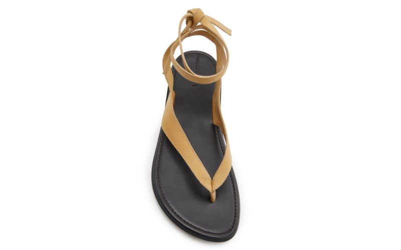 Suede Lace-Up Flat Sandals in Size 8 (Category: Flats & Sandals) located in Makati City. Submitted by agl.ph (Listing ID 1467741607, Image 2). Description: - Color: Beige with contrasting black soles - Style: Thong-style front strap with lace-up ankle design - Size: US8 (stamped on the bottom) - Condition: Brand new, never worn out - Special Feature: Protective plastic film still attached to the soles - Purchased on Amazon for $50.