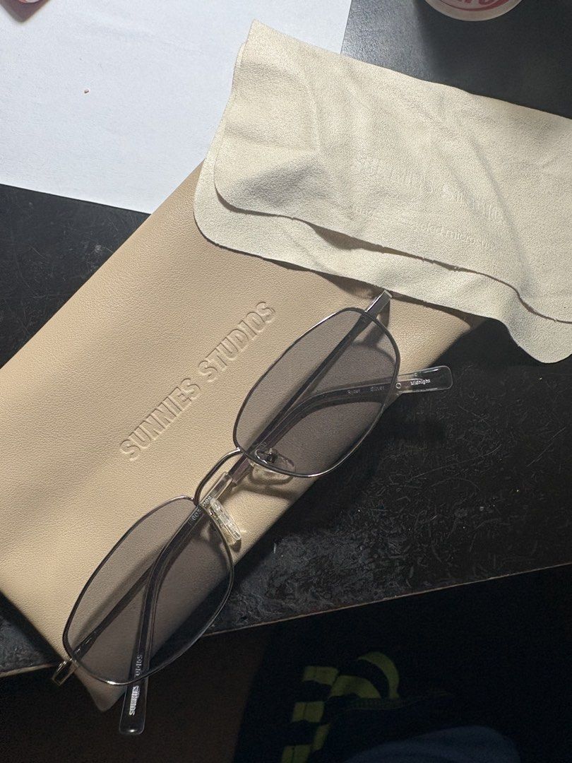 Sunnies Studios Ryder Silver Midnight Sunglasses (Category: Sunglasses & Eyewear) located in Manila. Submitted by iyadeclutters (Listing ID 1467743578, Image 1). Description: - Brand/Model: Sunnies Studios - Frame: Rectangular metal in silver with clear nose pads - Lenses: Midnight lenses, pristine and clean - Condition: Barely used, safely stored - Inclusions: Original beige leatherette sleeve pouch and matching cream microfiber cleaning cloth.