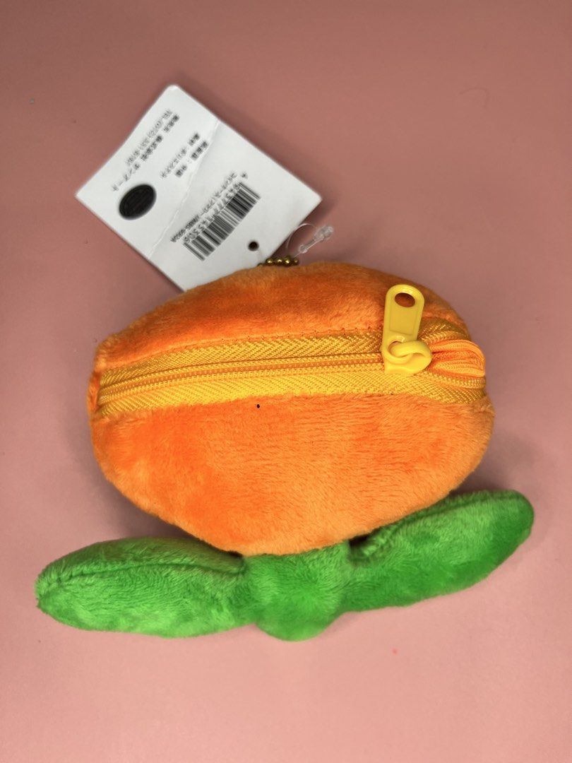 Super Mario Fire Flower Plush Coin Purse (Category: Purses & Pouches) located in Caloocan City. Submitted by snapshop_ph (Listing ID 1467645078, Image 3). Description: - Authentic Super Mario Fire Flower plush coin purse - Soft orange and yellow material with green leaf details - Secure zipper closure with orange mesh-lined interior - Includes golden ball chain strap and clasp for easy hanging on bags or keys - Comes with original hang tags (Grea