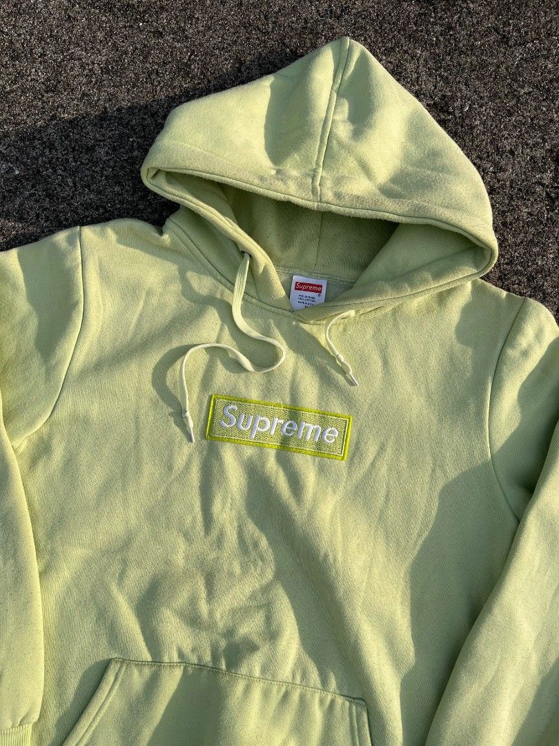 Supreme Lime Green Box Logo Hoodie (Category: Hoodies) located in Manila. Submitted by bognalosjo69319 (Listing ID 1467823768, Image 3). Description: - Authentic Supreme box logo hoodie in light lime green - Classic heavyweight cotton fleece pullover - Tonal embroidered box logo patch on the chest - Features a drawstring hood and front kangaroo pocket - Clean condition with heavy, premium quality fabric - Essential everyday streetwear staple.