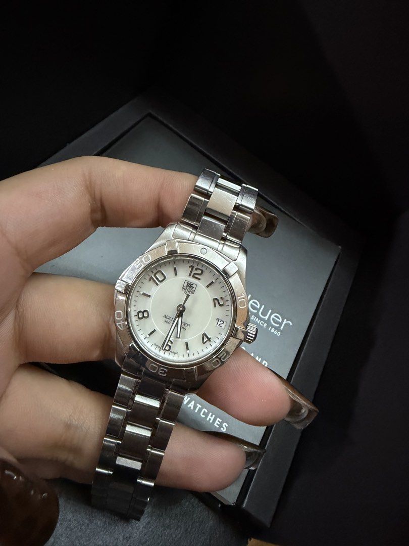 TAG Heuer Aquaracer 300M (Category: Luxury Watches) located in Manila. Submitted by paupreloveditems88 (Listing ID 1467701046, Image 1). Description: - Brand: TAG Heuer Aquaracer - Dial: White dial with bold Arabic numerals - Material: Stainless steel case and bracelet - Movement: Swiss quartz movement - Features: Rotating dive bezel, 300 meters water resistance - Inclusions: Original black TAG Heuer presentation box - Condition: Good working con