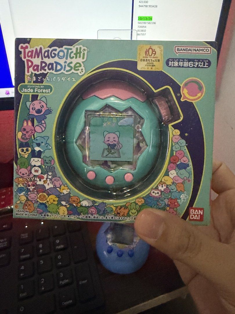 Tamagotchi Paradise Jade Forest (Category: Interactive Toys) located in Mandaluyong City. Submitted by raprap0302 (Listing ID 1467810862, Image 2). Description: - Brand: Bandai Namco - Edition: Tamagotchi Paradise - Jade Forest Edition (Japanese Toy Award Winner) - Design: Turquoise shell with cute pink top and buttons - Condition: Brand new, sealed, and intact box packaging - Perfect for collectors and Tamagotchi fans.