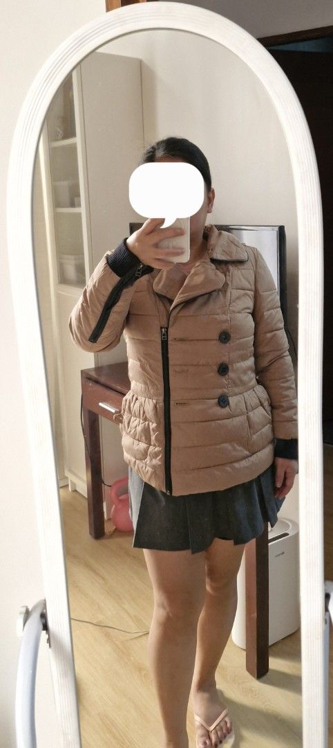Tan Puffer Jacket Winter Coat (Category: Coats, Jackets and Outerwear) located in Muntinlupa City. Submitted by prelovedbysandy (Listing ID 1467631303, Image 1). Description: - Brand/Model: BHZX Tan Quilted Puffer Jacket - Color: Versatile neutral khaki brown - Closure: Asymmetrical zipper with large black front buttons - Features: Collared neckline, ribbed black cuffs to block the cold, and front pockets - Fit: Pit-to-pit is approximately 18.5 i