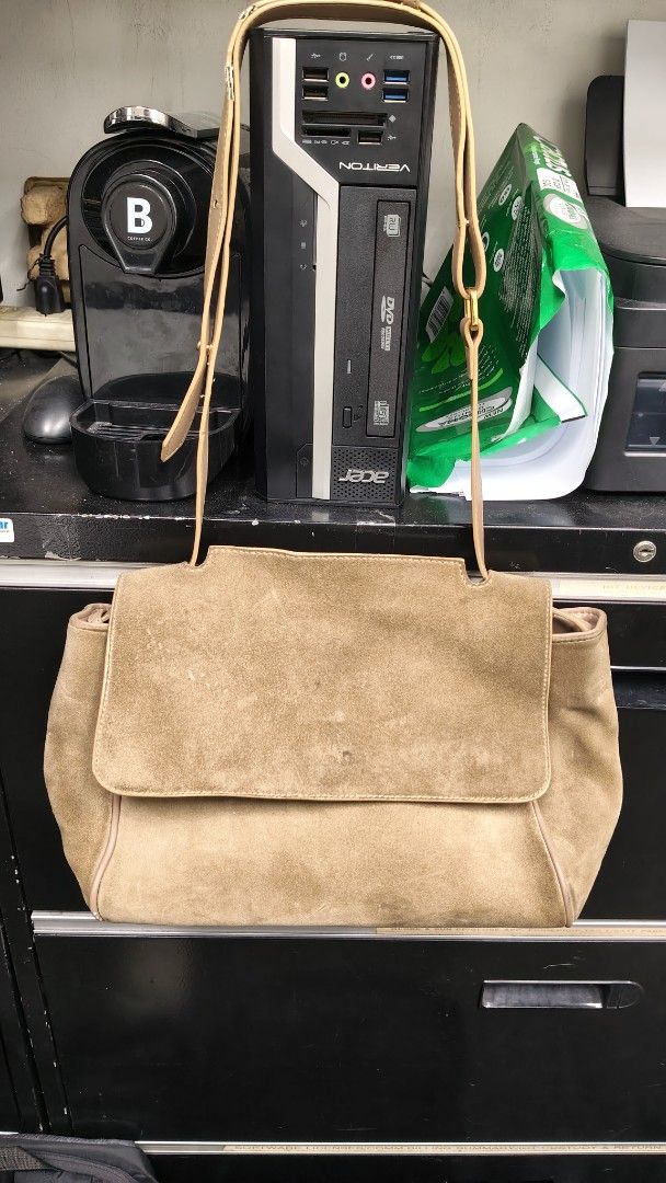 Tan Suede and Leather Shoulder Bag with Flap (Category: Shoulder Bags) located in Paranaque City. Submitted by joycelyn10 (Listing ID 1467719825, Image 2). Description: - Style: Two-tone leather and suede handbag - Exterior: Brown suede flap over smooth tan leather body - Hardware: Gold-tone metal with adjustable shoulder strap and buckle details - Interior: Spacious with a vibrant red lining - Condition: Shows visible wear on the suede flap and 