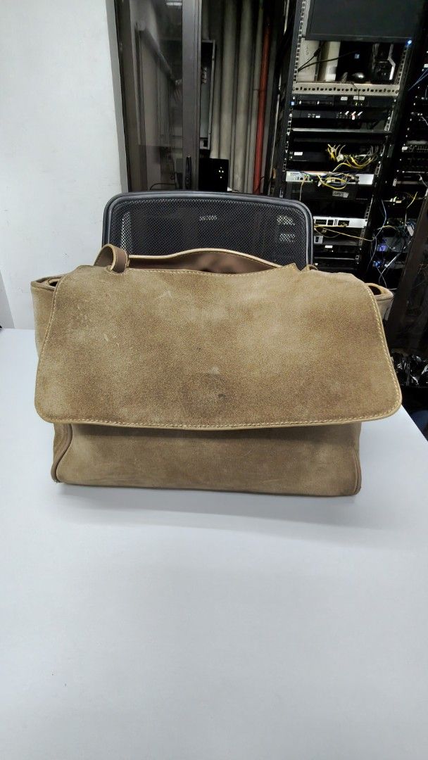 Tan Suede and Leather Shoulder Bag with Flap (Category: Shoulder Bags) located in Paranaque City. Submitted by joycelyn10 (Listing ID 1467719825, Image 1). Description: - Style: Two-tone leather and suede handbag - Exterior: Brown suede flap over smooth tan leather body - Hardware: Gold-tone metal with adjustable shoulder strap and buckle details - Interior: Spacious with a vibrant red lining - Condition: Shows visible wear on the suede flap and 
