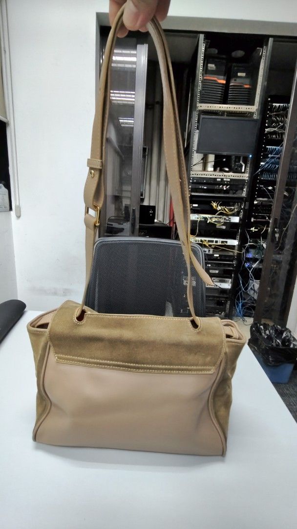 Tan Suede and Leather Shoulder Bag with Flap (Category: Shoulder Bags) located in Paranaque City. Submitted by joycelyn10 (Listing ID 1467719825, Image 3). Description: - Style: Two-tone leather and suede handbag - Exterior: Brown suede flap over smooth tan leather body - Hardware: Gold-tone metal with adjustable shoulder strap and buckle details - Interior: Spacious with a vibrant red lining - Condition: Shows visible wear on the suede flap and 