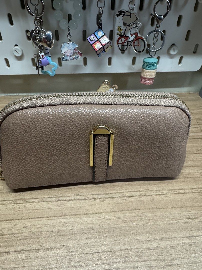 Taupe zip-around long wallet with gold hardware (Category: Wallets & Card holders) located in Manila. Submitted by xenasales (Listing ID 1467648376, Image 1). Description: - Color/Material: Taupe pebbled faux leather with dark brown fabric lining - Hardware: Gold-tone hardware with a distinct front metal clasp detail - Closure: Secure zip-around closure - Compartments: Multiple card slots, bill compartments, and a zippered coin pocket - Condition