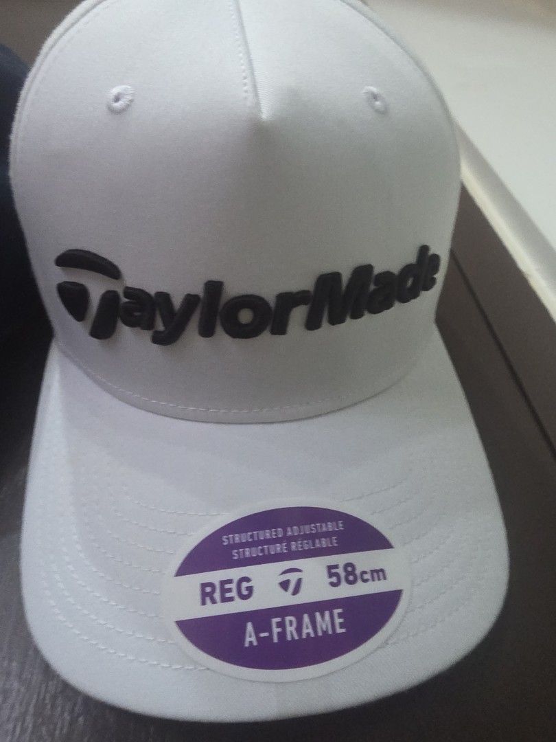 TaylorMade White A-Frame Golf Cap 58cm (Category: Caps & Hats) located in Manila. Submitted by read_description (Listing ID 1467655968, Image 1). Description: - Brand: TaylorMade - Color: Crisp white with bold black embroidered logo - Fit: A-frame structured fit, regular size 58cm - Closure: Adjustable strap at the back - Condition: Brand new with sticker still attached on the brim.